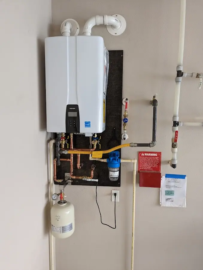 Professional plumber installing copper piping in a Emporia home